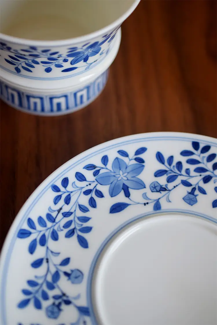 Chinese handmade cup and saucer showcasing intricate underglaze hand-painted motifs, reflecting exquisite craftsmanship.