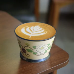 Handmade ceramic coffee cup with traditional painting, ideal for business latte moments.