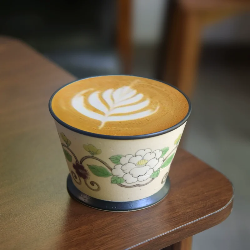 Handmade ceramic coffee cup with traditional painting, ideal for business latte moments.