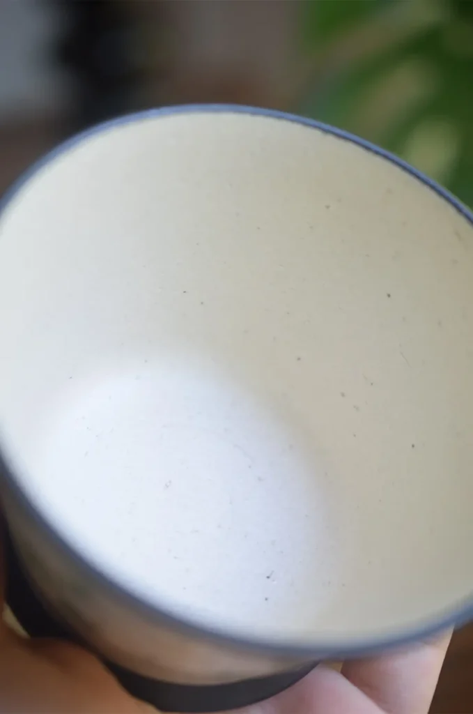 Handmade vintage ceramic cup reveals a smooth glazed interior, perfect for enjoying daily tea and coffee.