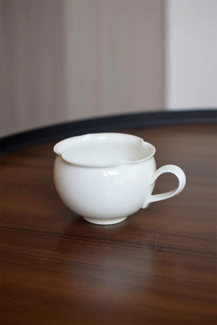 Handmade white ceramic coffee mug combines luxury and simplicity, ideal for everyday use.