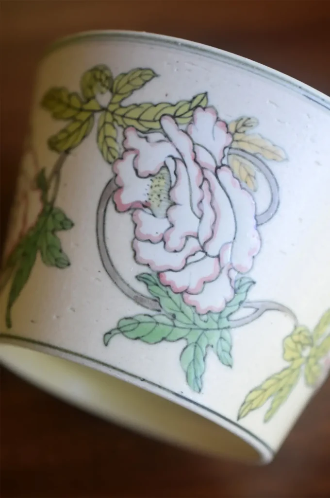 Underglaze peony ceramic cup features custom hand-painted design rooted in traditional artistry.