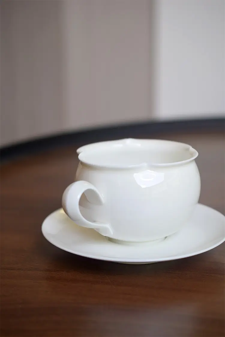 Handmade white ceramic cup and saucer set, custom-crafted for refined table settings and modern European-style decor.