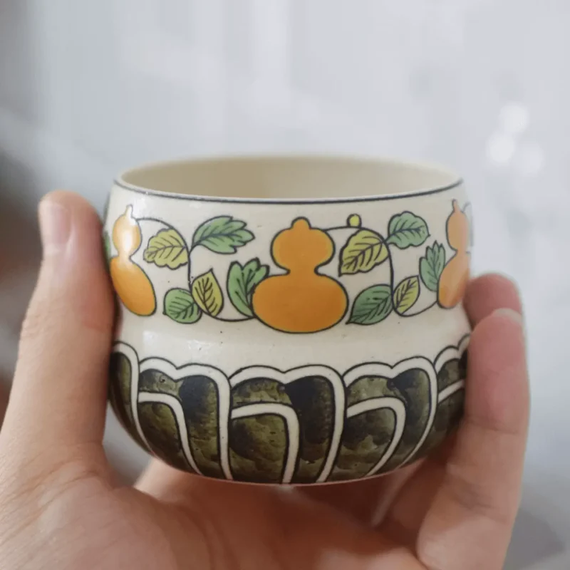 Custom ceramic cup held in hand, 170ml handmade porcelain for daily use.