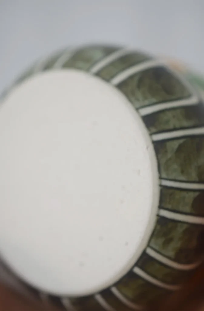 Custom ceramic cup with flat, stable bottom showing detailed craftsmanship.