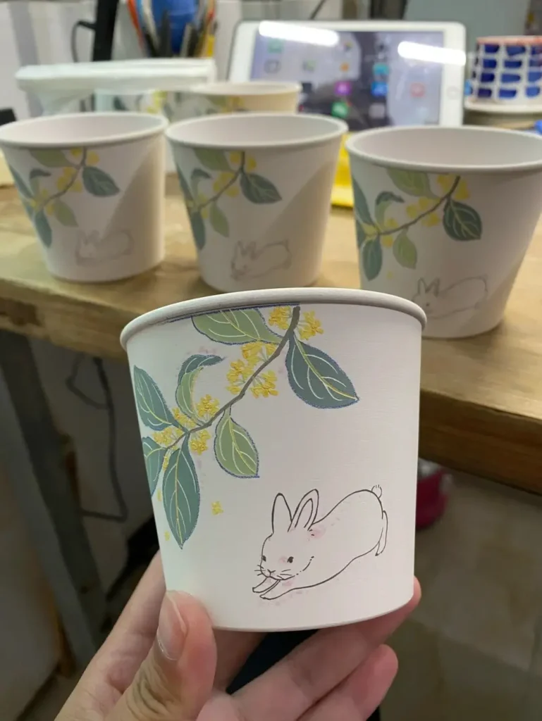 Custom ceramic mug with hand-painted design waiting for clear glaze coating.