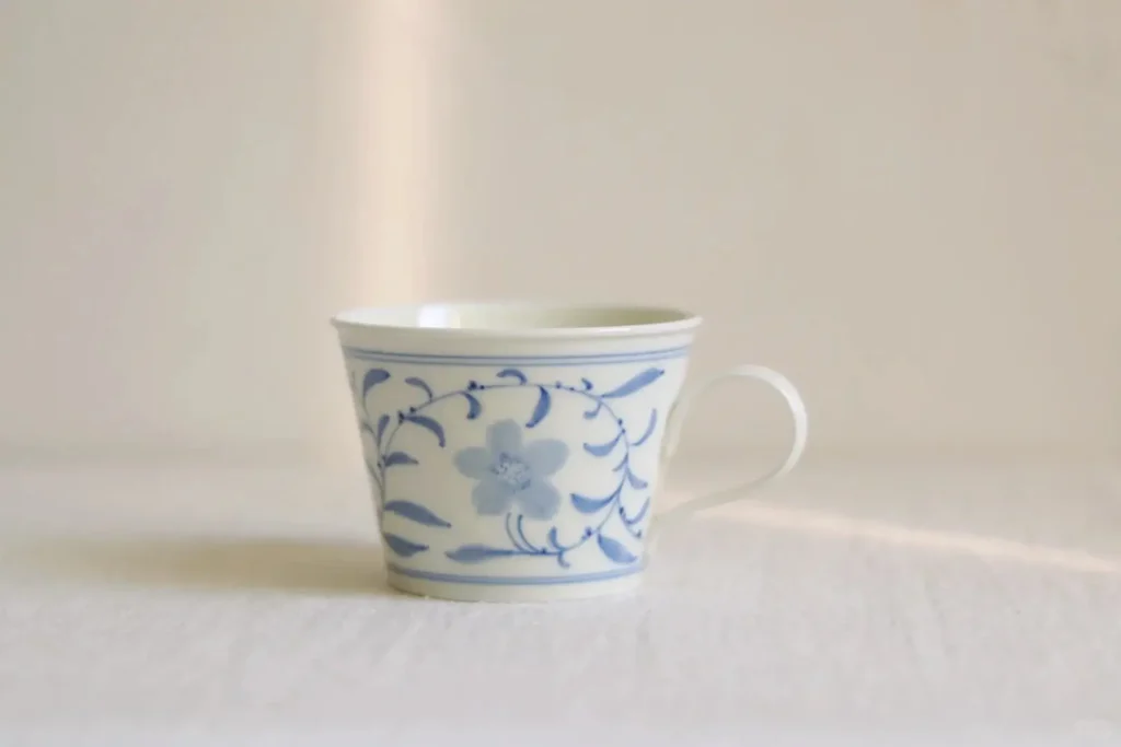 Celebrate daily rituals with a hand-painted ceramic coffee mug crafted using eco-friendly underglaze polychrome techniques.