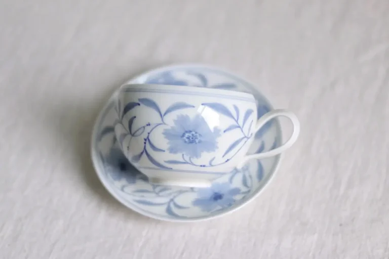 Hand-painted custom ceramic coffee mug with blue and white vine pattern for everyday use