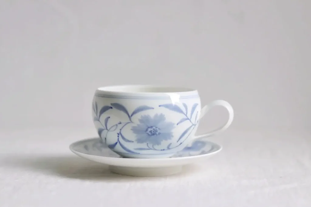 Experience timeless charm with a handmade ceramic latte mug saucer set featuring hand-painted vine motifs in traditional blue-and-white craftsmanship.