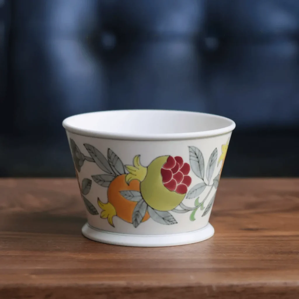 Handmade ceramic cup with hand-painted pomegranate design symbolizing blessings, ideal eco-friendly drinkware for coffee, tea, or daily beverages.