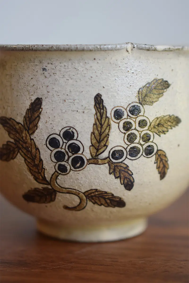 Hand-painted ceramic cup featuring underglaze blue-and-white loquat design, showcasing intricate detailing and traditional craftsmanship.