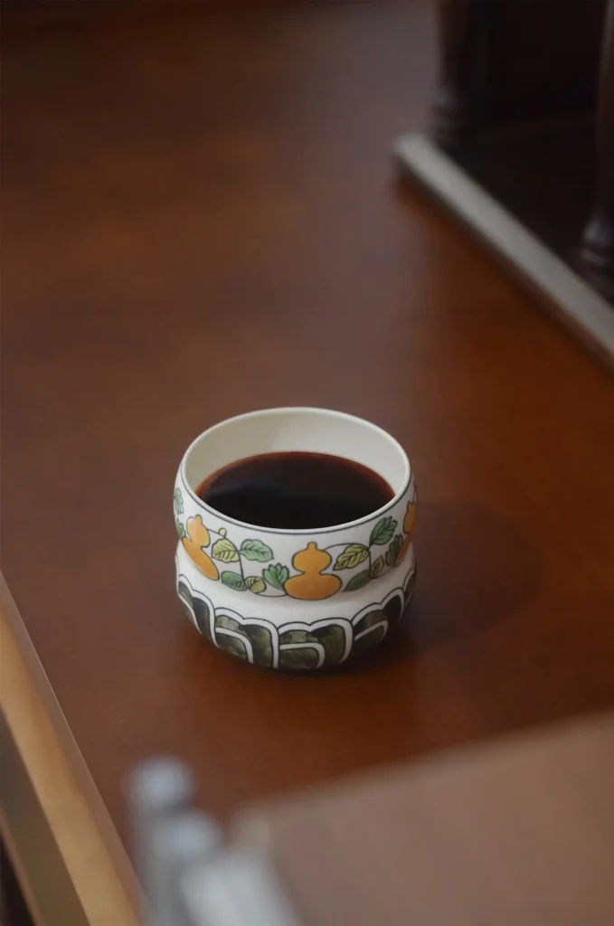 Hand-painted gourd motif tea cup with underglaze painting, crafted for handmade tea art lovers.