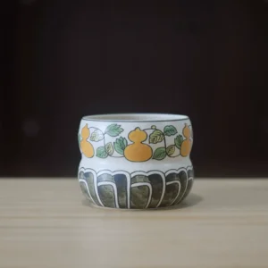 Hand-painted gourd motif ceramic tea cup with symbolic design and underglaze art.
