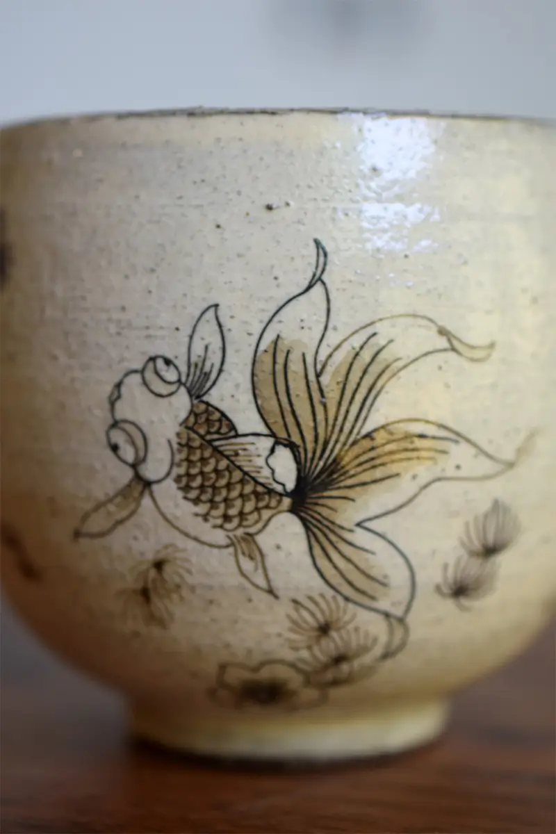 Hand-painted coffee mug featuring underglaze blue and goldfish motif to showcase traditional ceramic craftsmanship
