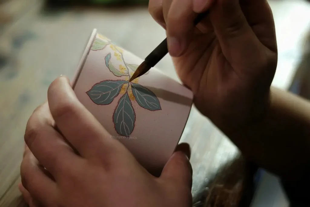 Hand-painting on custom ceramic bisque requires artist’s precision and refined brushwork