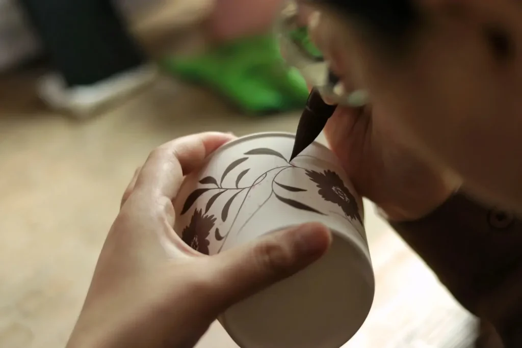 Hand-painted ceramic mug by artisan showcasing fine craftsmanship