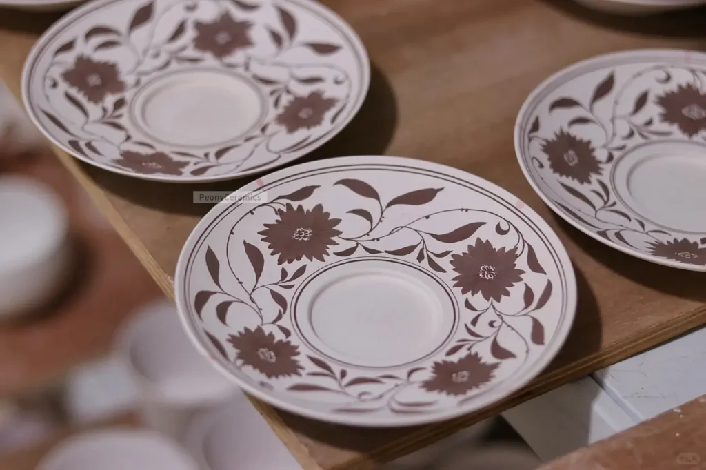Artisan hand-painted ceramic plates using underglaze polychrome, ideal for everyday tableware