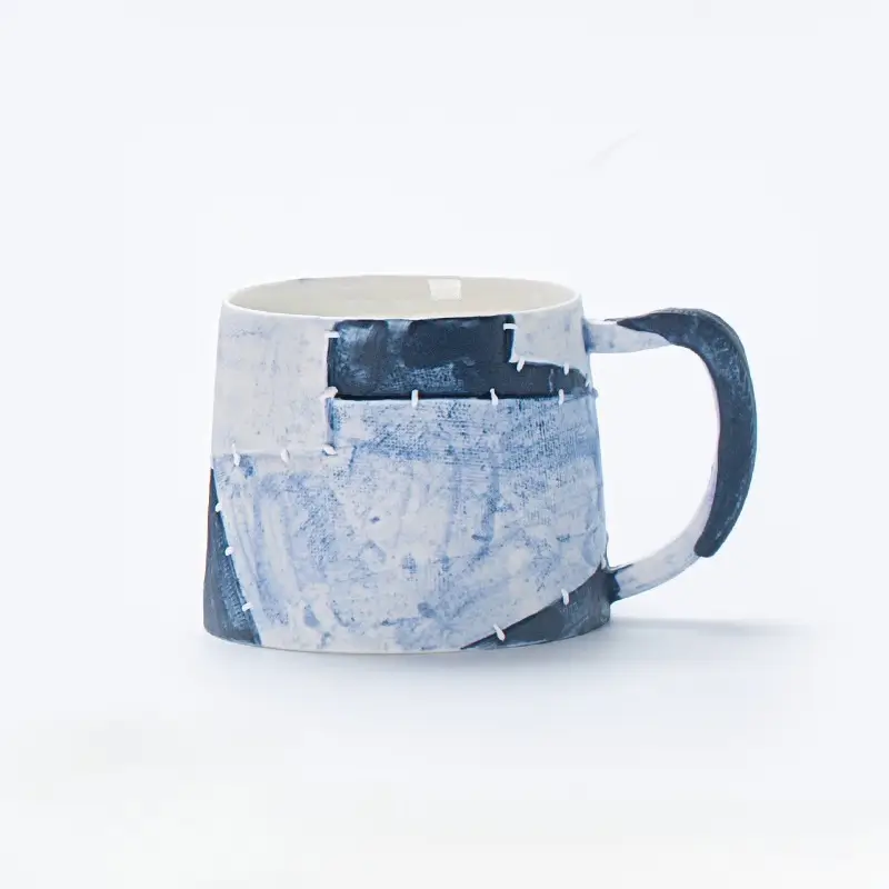 Handmade ceramic coffee mug with traditional Japanese sashiko pattern, inspired by vintage textile stitching.