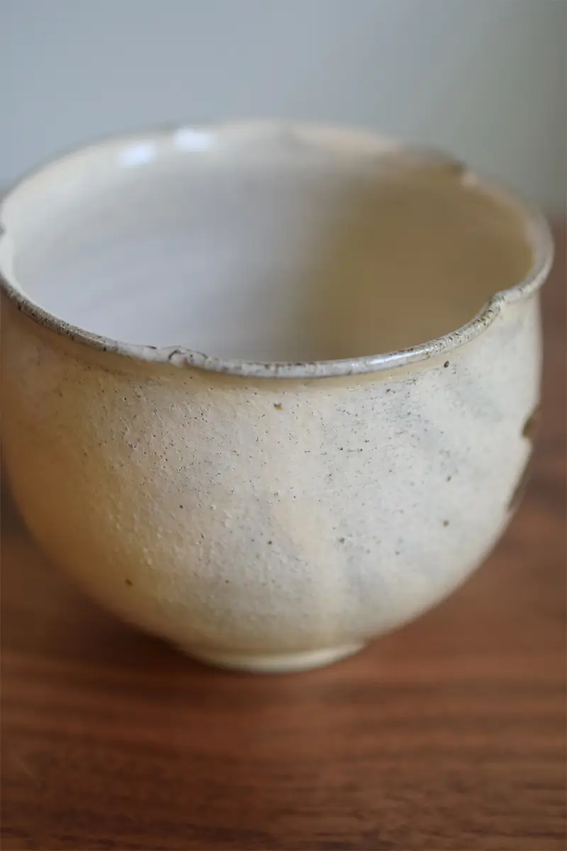 Handmade coffee cup crafted from coarse clay, with natural black specks on the surface—perfectly normal and adds to its rustic charm.
