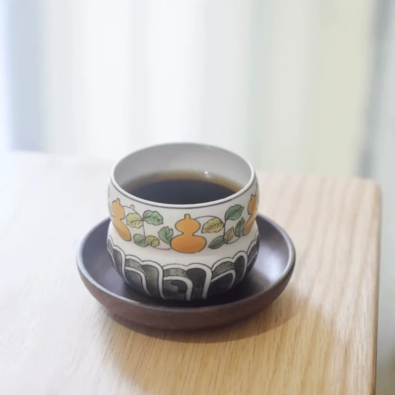 Handmade underglaze ceramic tea cup with gourd motif, crafted for tea lovers.