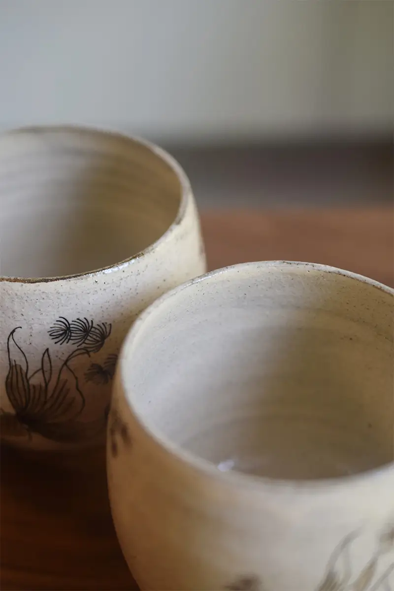 Vintage ceramic cup with coarse clay glaze and natural speckled surface