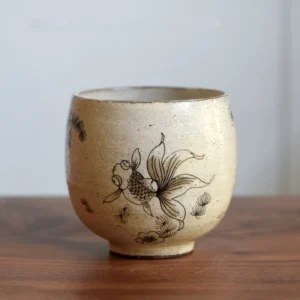 Vintage ceramic cup with hand-painted underglaze goldfish for daily drinks