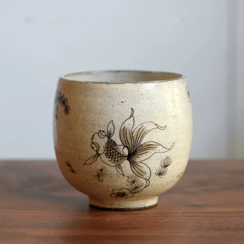 Vintage ceramic cup with hand-painted underglaze goldfish for daily drinks